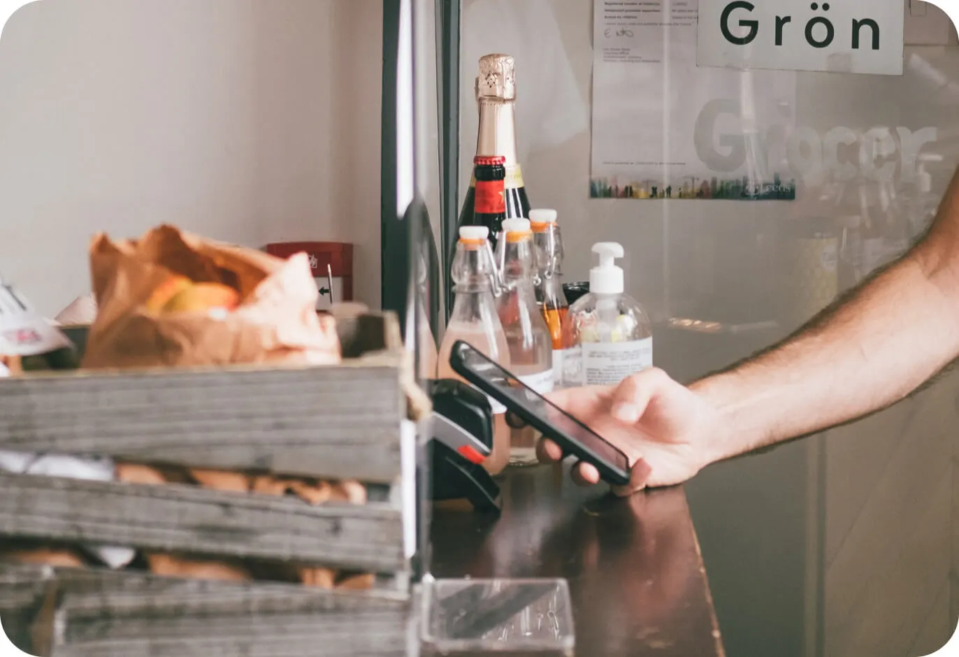 customer paying with his phone at counter