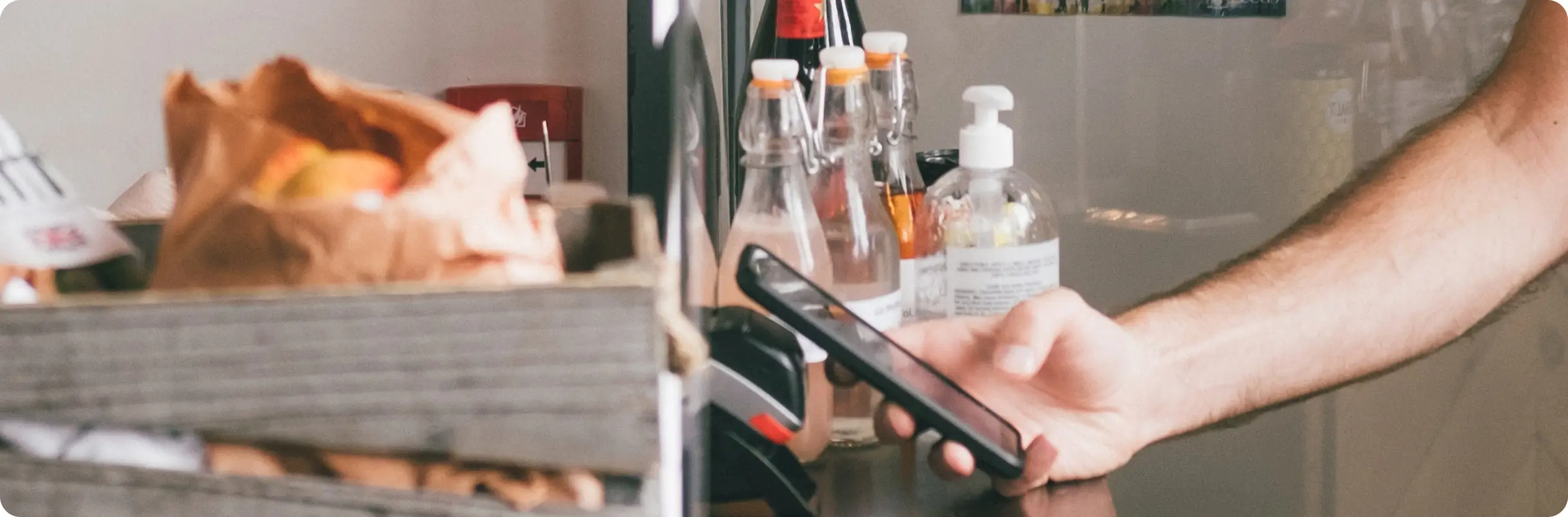 customer paying with his phone at counter